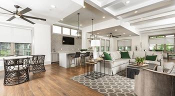 Resident clubhouse with seating area, communal kitchen, and business center The Retreat at Fairhope Village in Fairhope, AL
